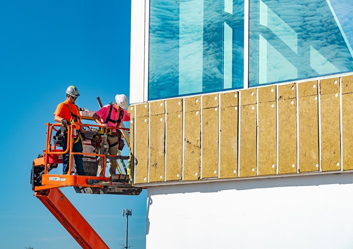 Men on a lift cleaning building windows