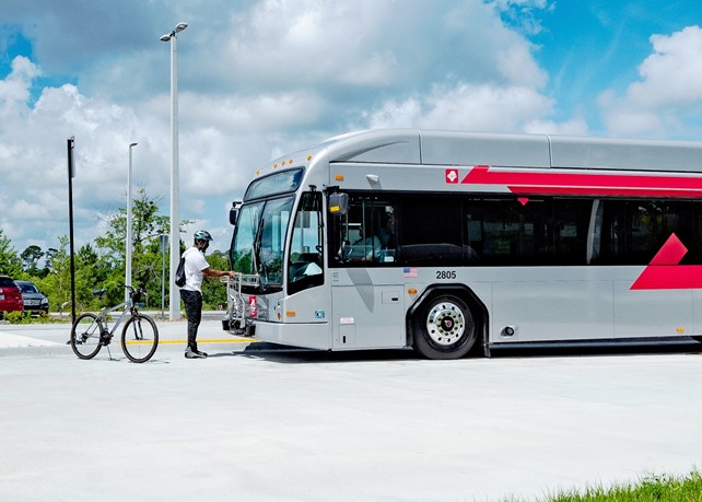Man in front of a bus